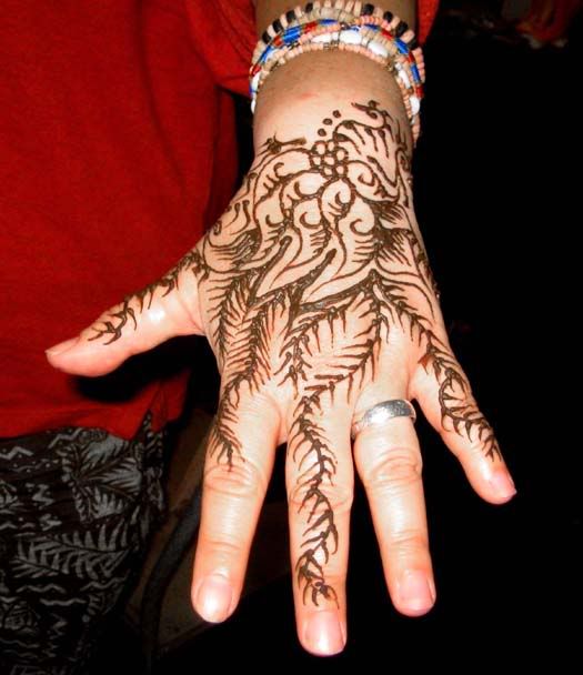 Traditional tattoo on the palm of the hand with natural ink material